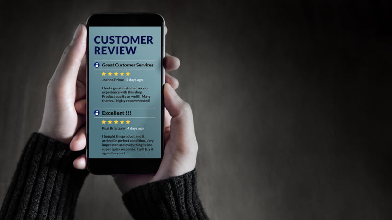 Hand Holding a Mobile Customer Review Page