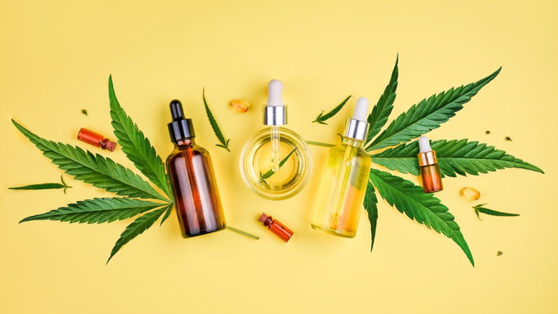 THC Products with Hemp Leaves in Yellow Background