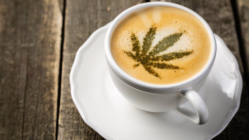 Cup of Coffee with Hemp Leaf Design Topping