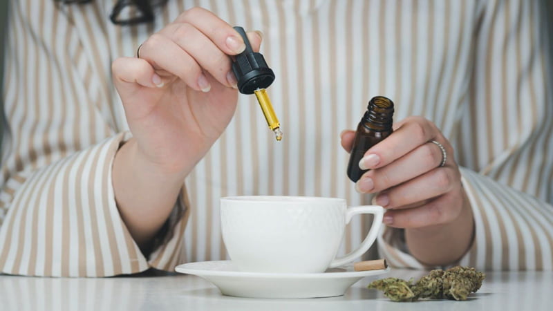 Woman Dropping Cannabinoids on her Coffee