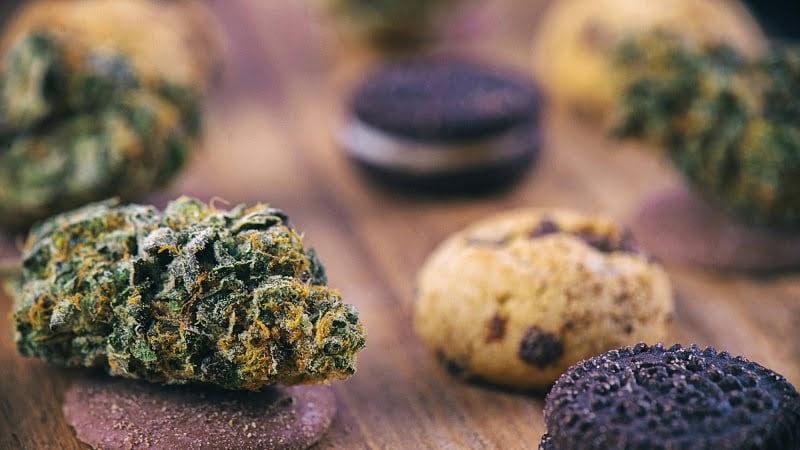 a cannabis bud over infused chocolate chip and cookies