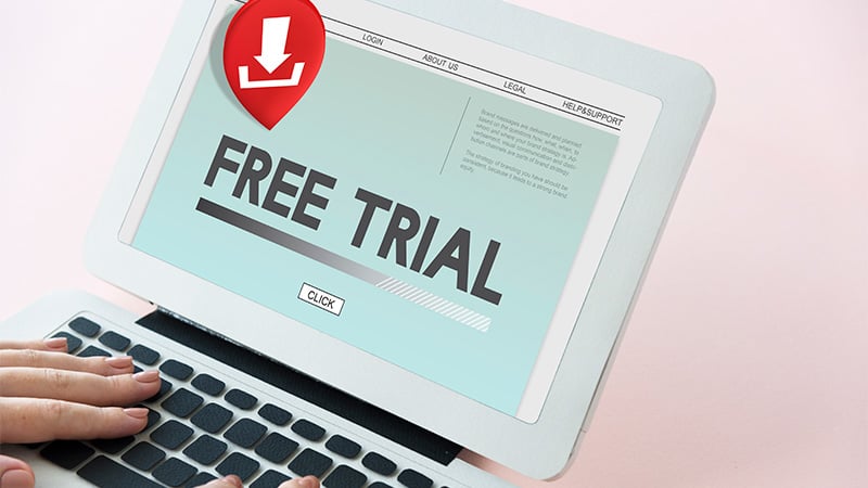 Person Holding a Laptop with Free Trial Print