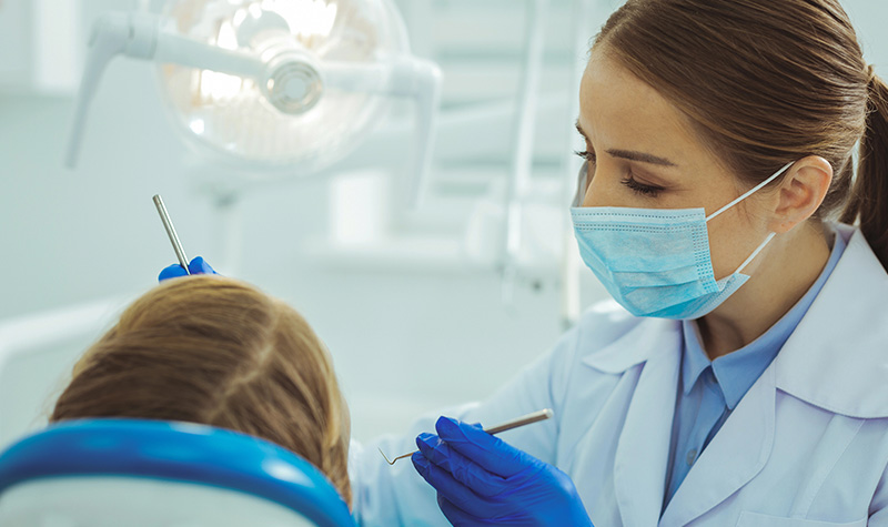 A dentist checking on her patient