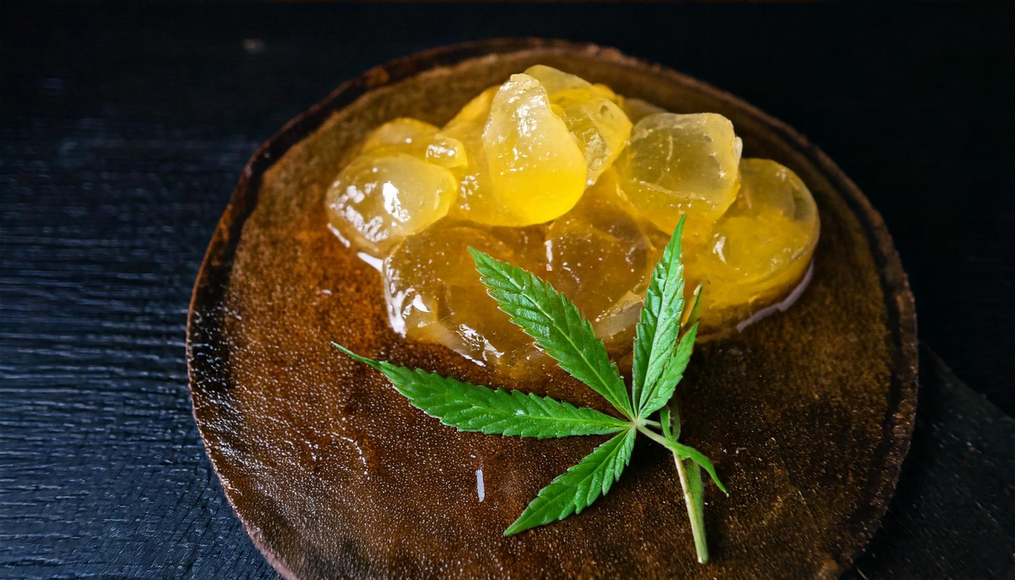 Live rosin with a cannabis leaf